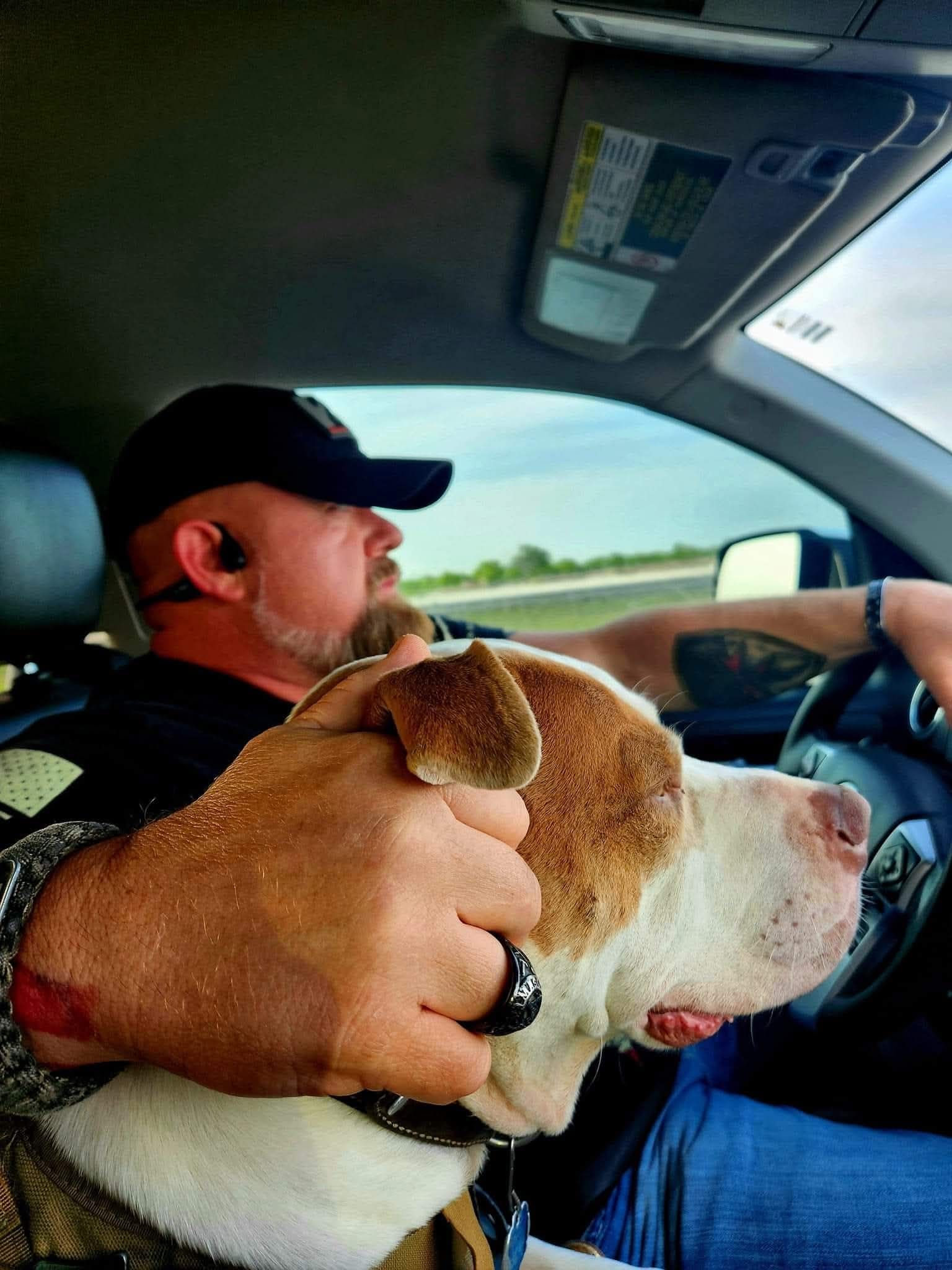 James driving with Lincoln tucked against him in the cab of his truck